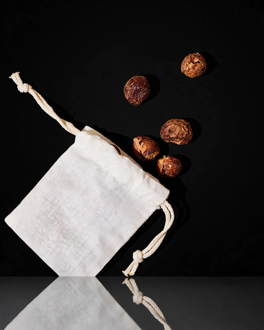 Laundry soap nuts on black background